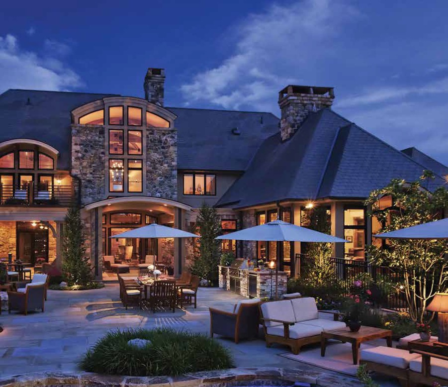 A well-lit home and large patio illuminated by Lutron lighting.