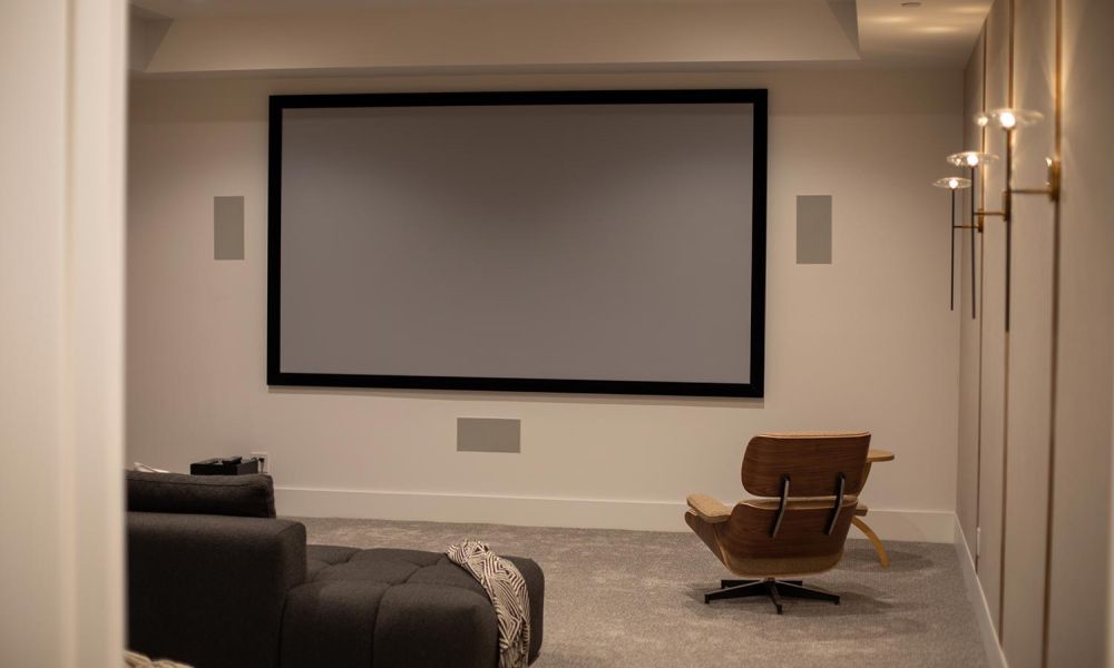 Straight-on view of theater with large screen and lounge seating