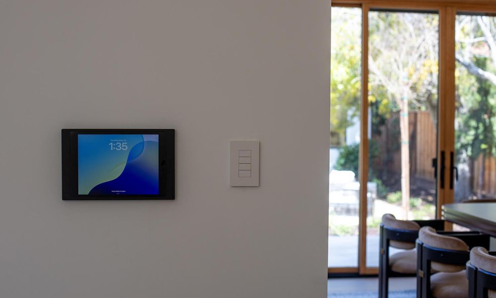 Wall-mounted smart panel and switch near glass doors