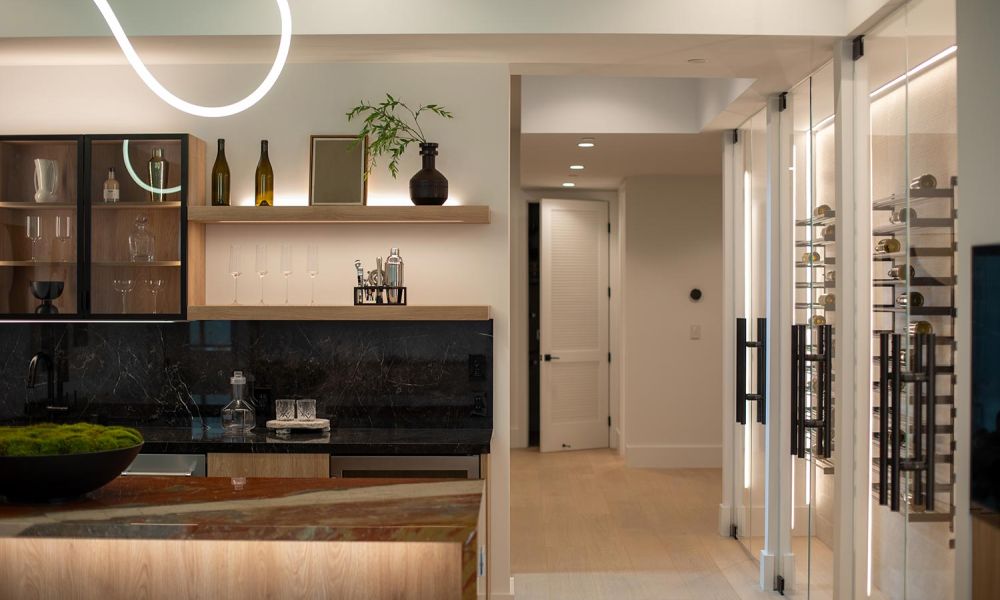 Contemporary bar with floating wood shelves and glass wine storage illuminated by warm LED lighting
