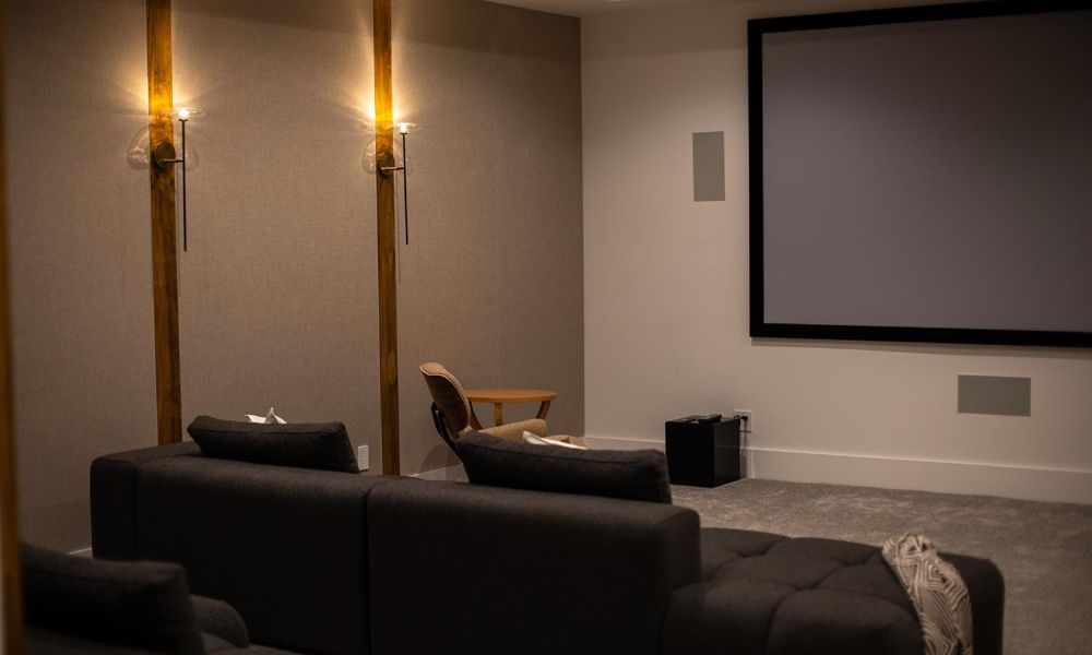 Home theater with soft wall lighting and wooden accent chair
