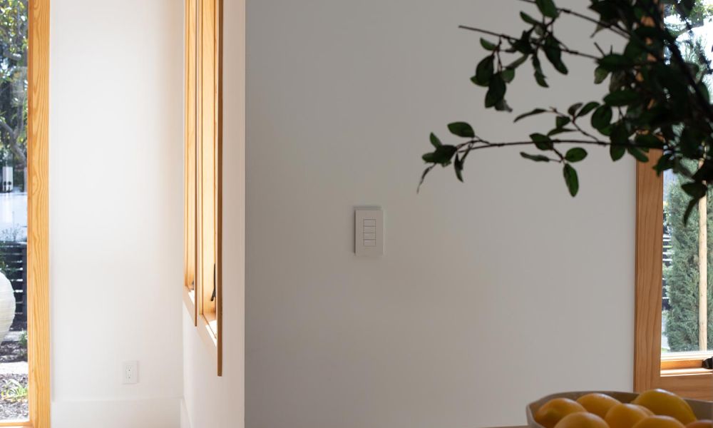 Smart switch on wall with window views in the background